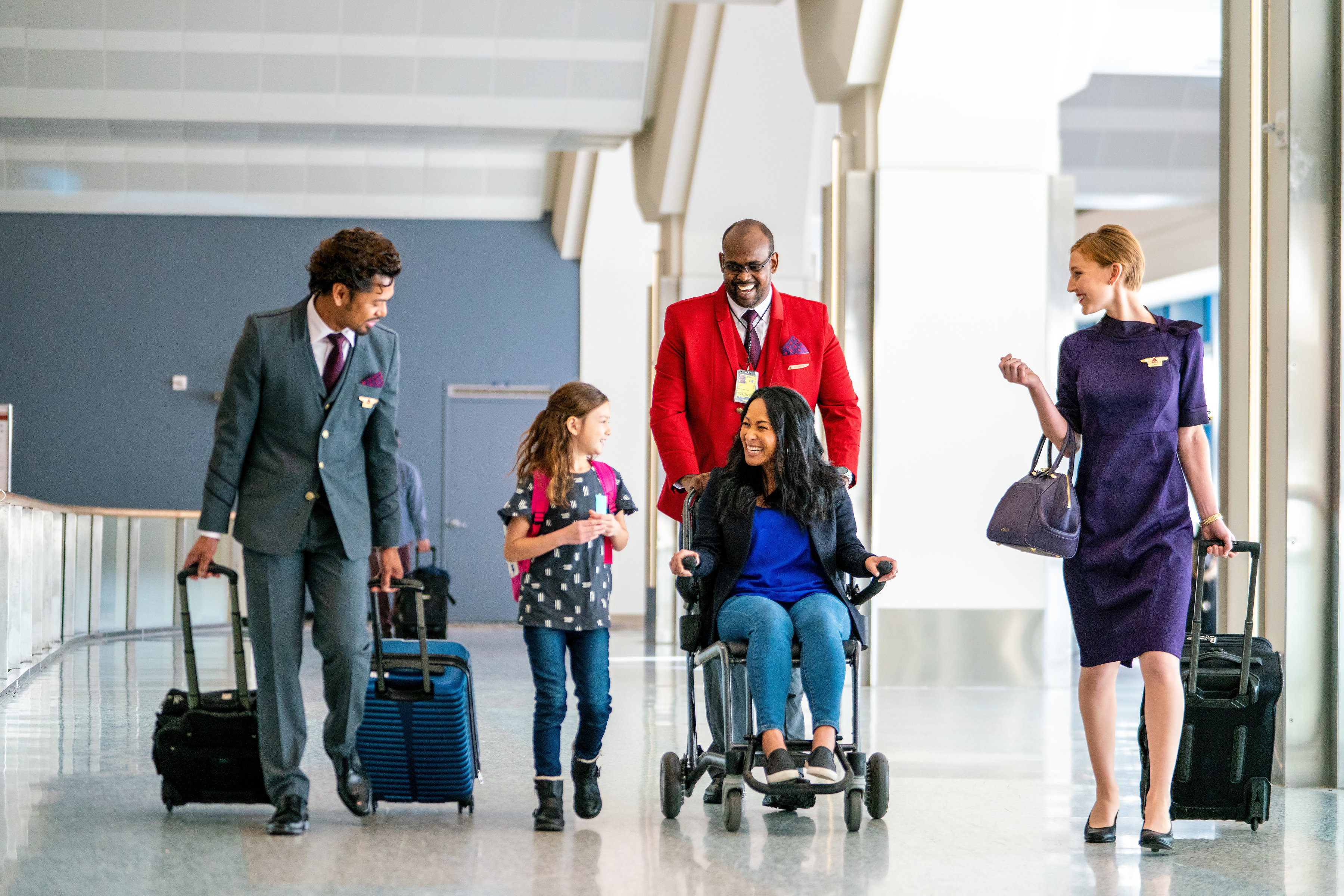 Delta employee assisting a traveler through the airport