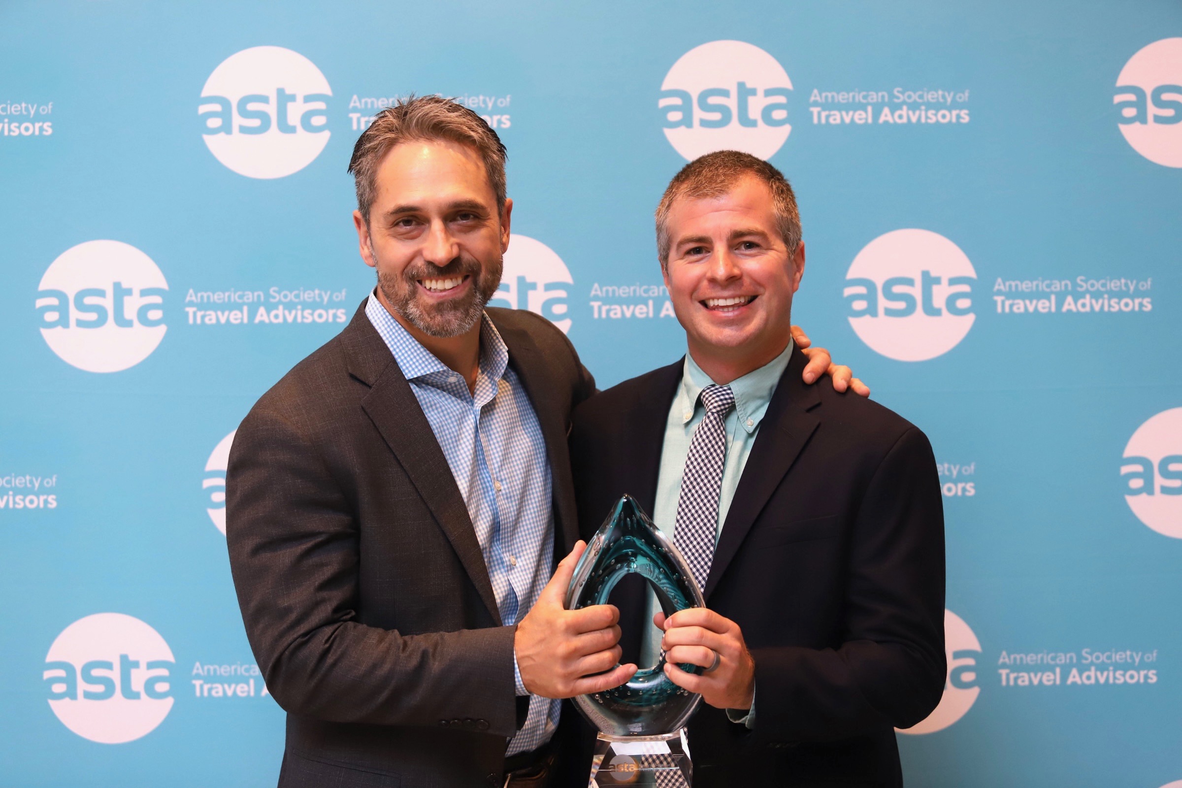 Pictured: Marc Casto, President of Flight Centre Travel Group and Chair of the ASTA Board of Directors and Mat Kutches, General Manager - Agency Sales at Delta Air Lines holding 2022 ASTA Green Partner in Travel Award